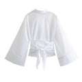 Mjlovers kimono wrap blouse in lightweight fabric, featuring a relaxed fit and elegant design, displayed on a hanger.