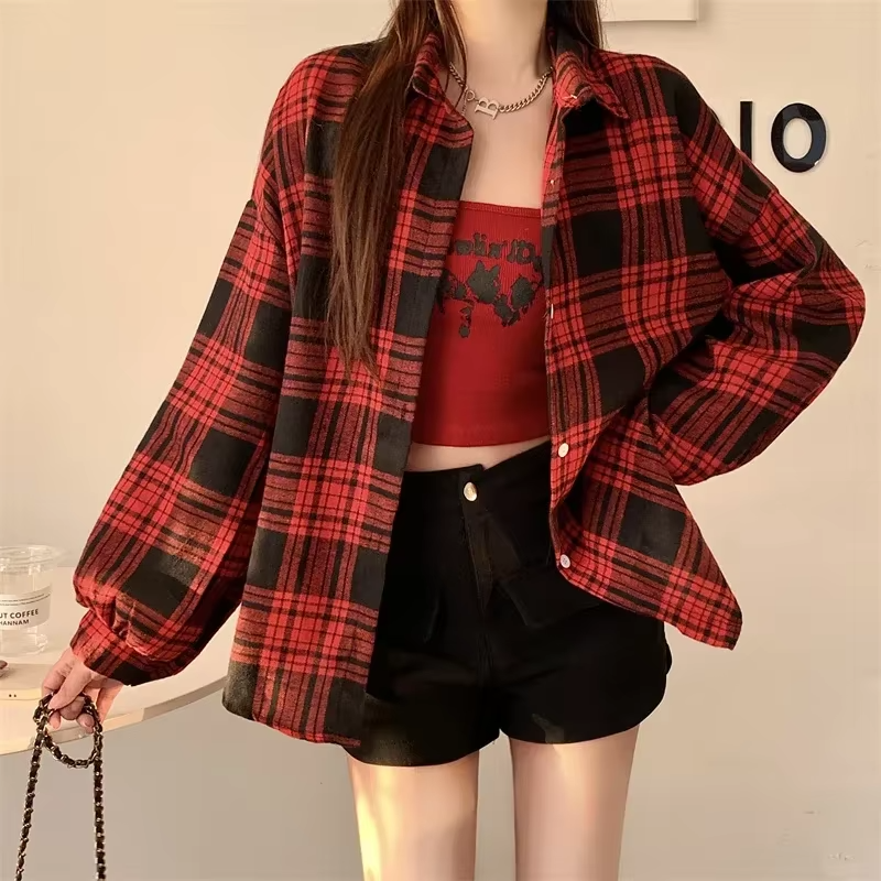 Women's oversized plaid shirt by mjlovers featuring a classic checkered pattern and relaxed fit, shown hanging on a wooden hanger