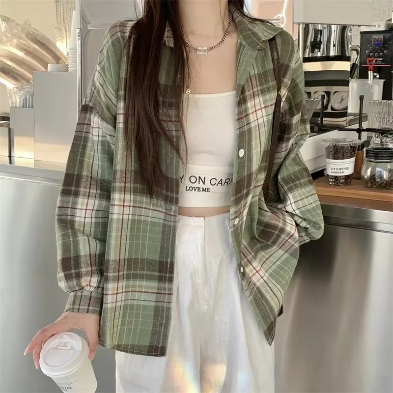 Women's oversized plaid shirt by mjlovers, featuring a relaxed fit and classic checkered pattern, displayed on a hanger.