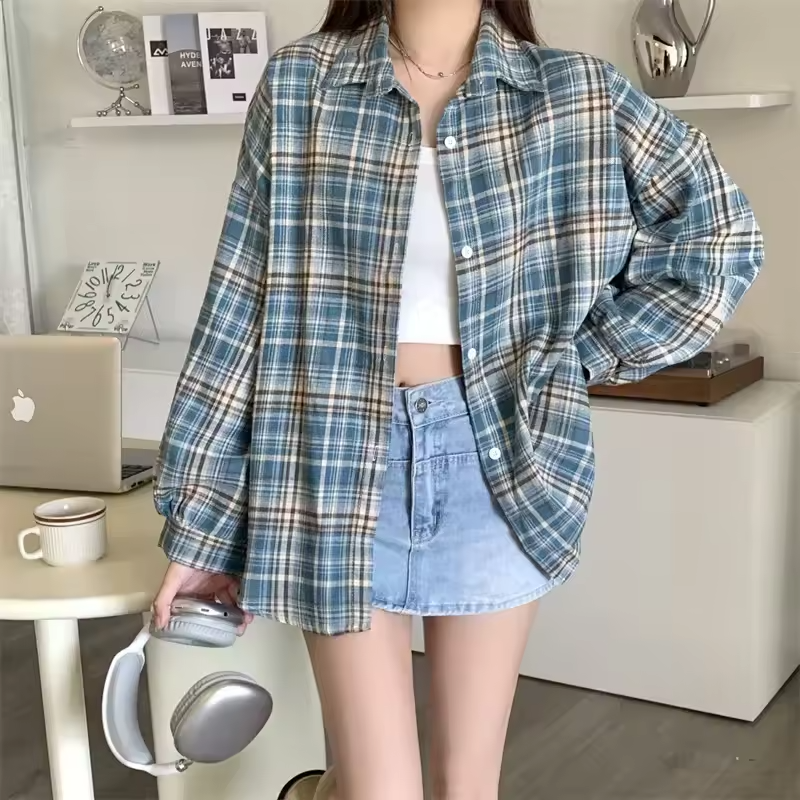 Women's oversized plaid shirt from mjlovers, featuring a classic checkered pattern and relaxed fit, displayed on a hanger.