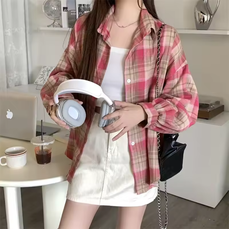 Women's oversized plaid shirt by mjlovers featuring a classic checkered pattern and relaxed fit, shown on a model.