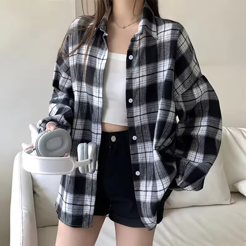 Women's oversized plaid shirt by mjlovers, shown in a relaxed fit with classic plaid pattern, long sleeves, and button front.